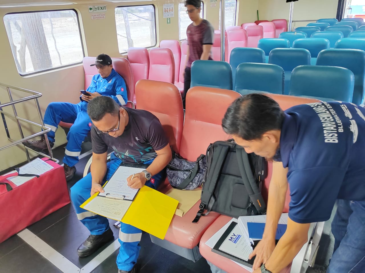 Surveyors reviewing certification documents onboard a passenger ferry