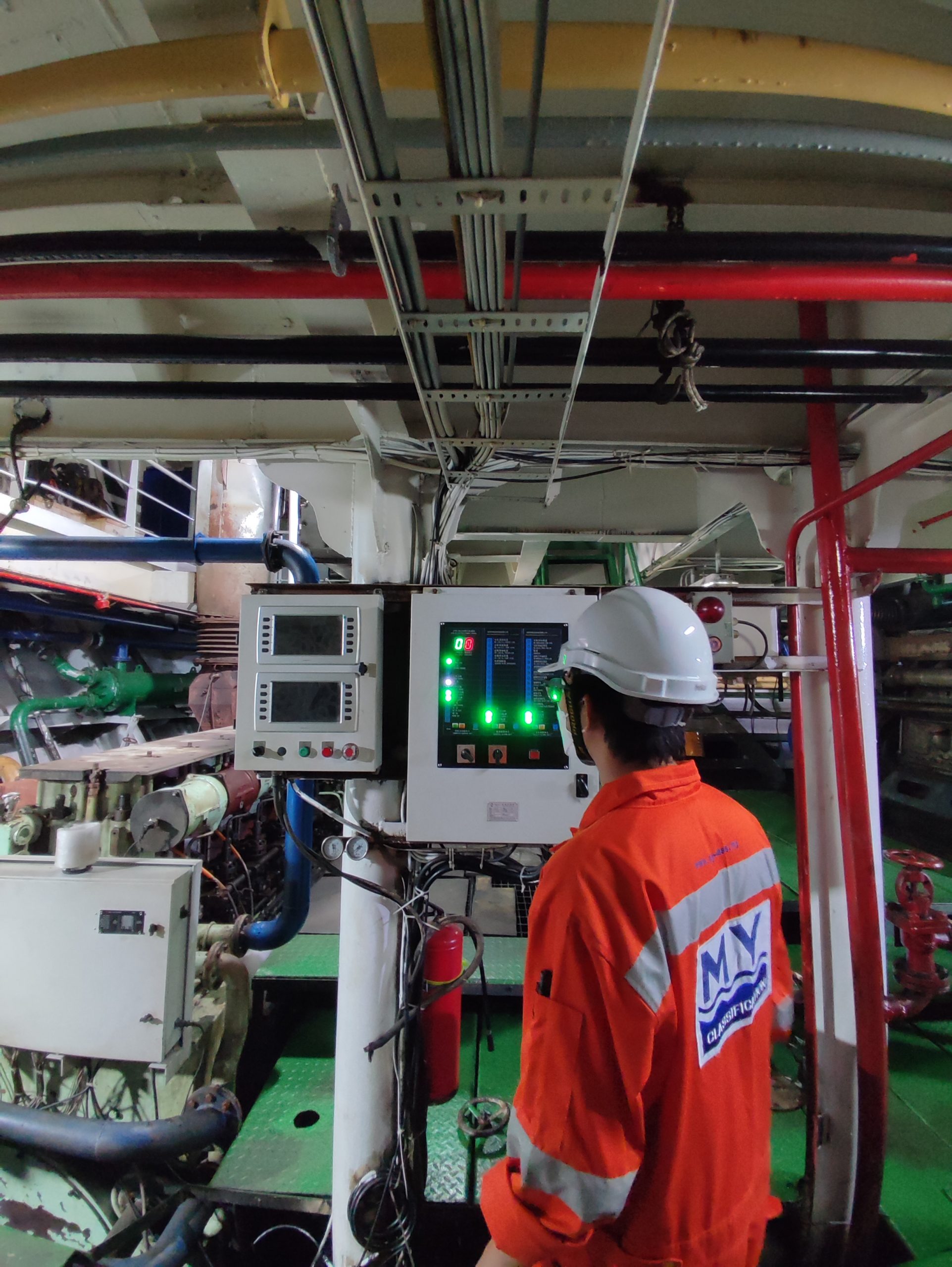 Surveyor checking an engine room control panel