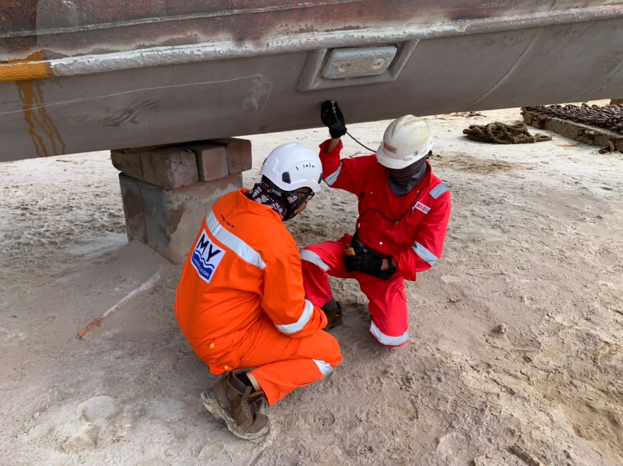 Surveyor inspecting a vessel's rudder and stern gear
