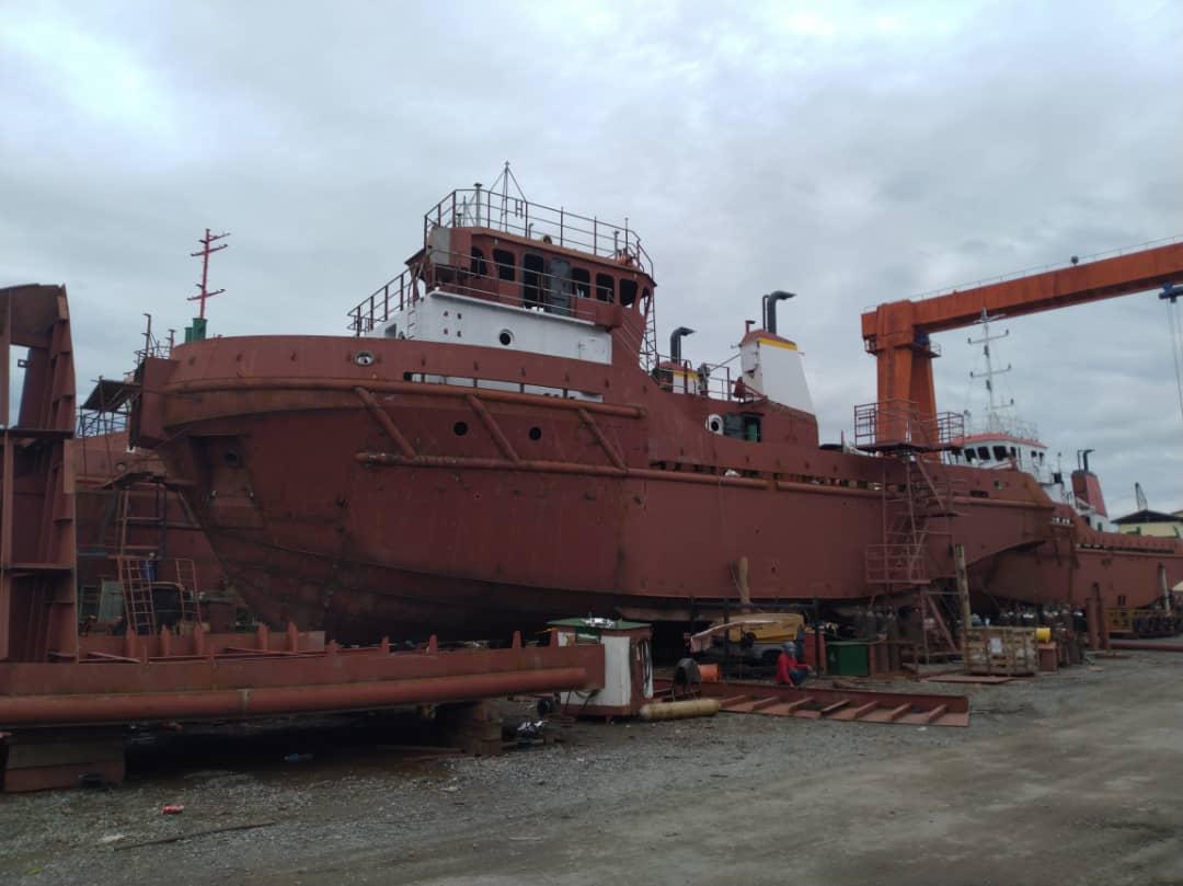 A steel hull under survey in dry dock